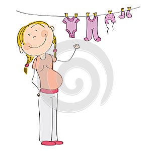 Happy pregnant woman hanging clothes for her unborn baby girl