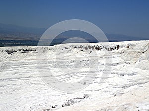 Original Pamukkale place in Turkey in Asia landscape with limestone pools with blue warm water