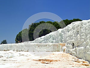 Original Pamukkale place in Turkey in Asia landscape with limestone pools with blue warm water