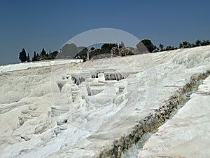 Original Pamukkale place in Turkey in Asia landscape with limestone pools with blue warm water