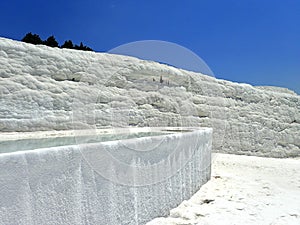 Original Pamukkale place in Turkey in Asia landscape with limestone pools with blue warm water