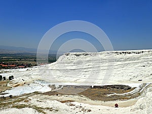 Original Pamukkale place in Turkey in Asia landscape with limestone pools with blue warm water