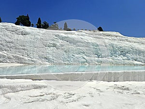 Original Pamukkale place in Turkey in Asia landscape with limestone pools with blue warm water