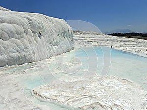 Original Pamukkale place in Turkey in Asia landscape with limestone pools with blue warm water