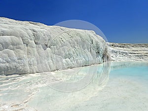 Original Pamukkale place in Turkey in Asia landscape with limestone pools with blue warm water