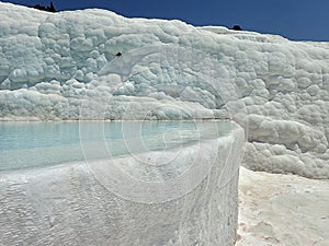 Original Pamukkale place in Turkey in Asia landscape with limestone pools with blue warm water