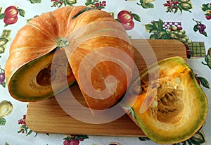 Original pumpkin with yellow-green pulp, cut into two unequal parts