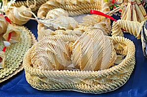 Original Souvenirs of woven straw are sold at the fair.
