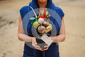 The original unusual edible vegetable and fruit bouquet with card in girl hands