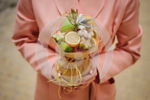 The original unusual edible vegetable and fruit bouquet in woman hands