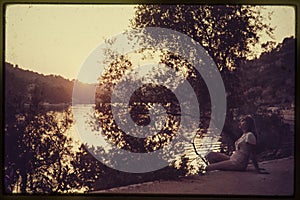 Original vintage colour slide from 1960s, young woman sitting by