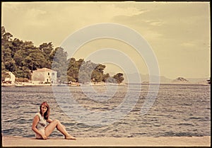 Original vintage colour slide from 1960s, young woman sitting by