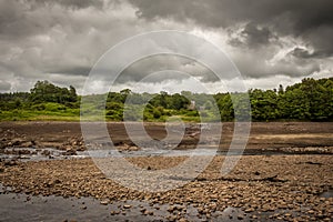 The original Water of Ken river bed exposed and the Earlstoun Castle ruin