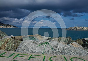 An original written Italian office on rocks at the sea