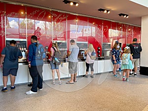 People pouring soda from a sample soda fountain