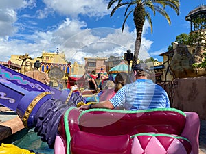 People riding the Aladdin Magic Carpet ride  at Disney World