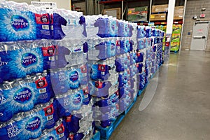 Stacks of Nestle bottled water at a retail store