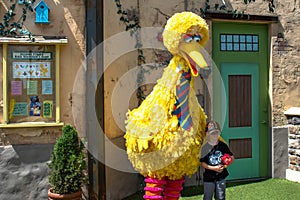 Child taking picture with Big Bird on Sesame Street at Seaworld 76