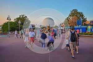 People walking ,taking pictures and  Plant Goofy on Spaceship Earth background in Epcot at Walt Disney World.