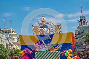 Donald Duck in Mickey and Minnie`s Surprise Celebration parade on lightblue sky background at Walt Disney World  15