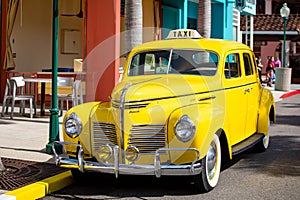 Orlando, USA - Feb. 12, 2021: Vintage yellow cab taxi parked along the street