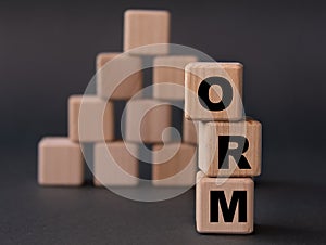 ORM - acronym on wooden cubes on a dark background