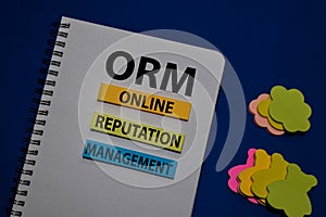 ORM - Online Reputation Management acronym write on sticky note isolated on Office Desk