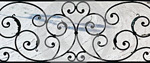 Ornament forged metal decorative pattern on a background of snow