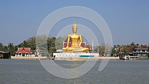 Ornament: huge gold buddha statue near river