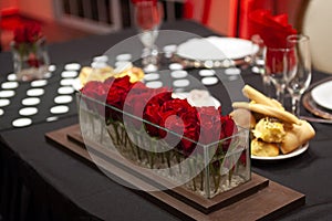 ornament of red roses on an event table photo