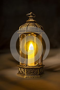 Ornamental Arabic lantern with burning candle glowing