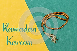 Ornamental Arabic rosary, Ramadan Kareem or Eid Greeting Card. Ramadan Mubarak. Translated: Happy