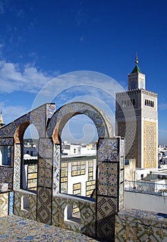 Ornamental arches on roof top terrace and mosque tower in Tunisia