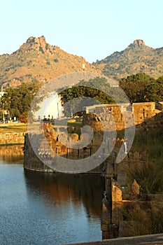 Ornamental battlement and trench at vellore fort with hills beautiful landscape photo