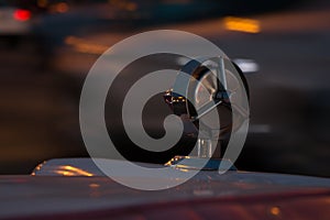 Ornamental chrome detail of the back of a classic car holding one of the car`s lights