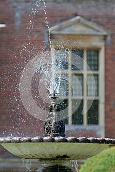 Ornamental garden water fountain. Classical water feature.