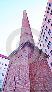 Ornamental industrial chimney in a square in Sabadell, Barcelona