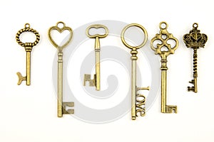 Ornamental medieval vintage keys with intricate forging, composed of fleur-de-lis elements, victorian leaf scrolls and heart shape