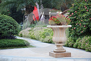 Ornamental stone flowerpot in garden