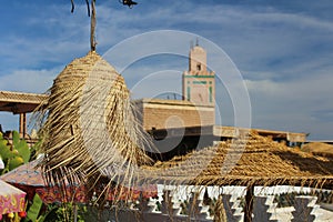 Ornamental straw lamp and umbrela in a terrace in old city of Marrakech
