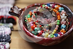 Ornamentals in ceramic plate on wooden surface