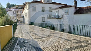 Cobblestone roadway of the bridge across Almonda River, at Alexandre Herculano Street, Torres Novas, Portugal photo