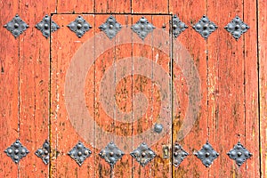 Ornamented orange wooden door