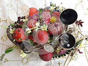 Ornamented red Easter egg with fresh wild flowers and herbs