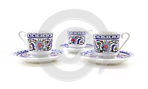 Ornamented teacups isolated on white