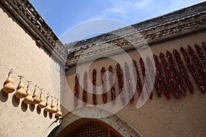 Ornaments of ladle and pepper hang in the sunken courtyard