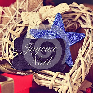 Ornaments and text joyeux noel, merry christmas in french