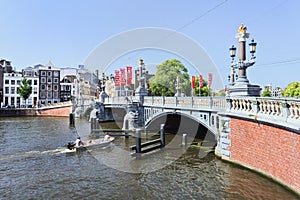 Ornate ancient bridge with a boat in Amsterdam