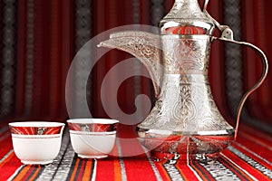 Ornate arabian tea cups and a dallah tea pot