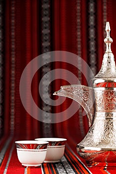 Ornate arabian tea cups and a dallah tea pot